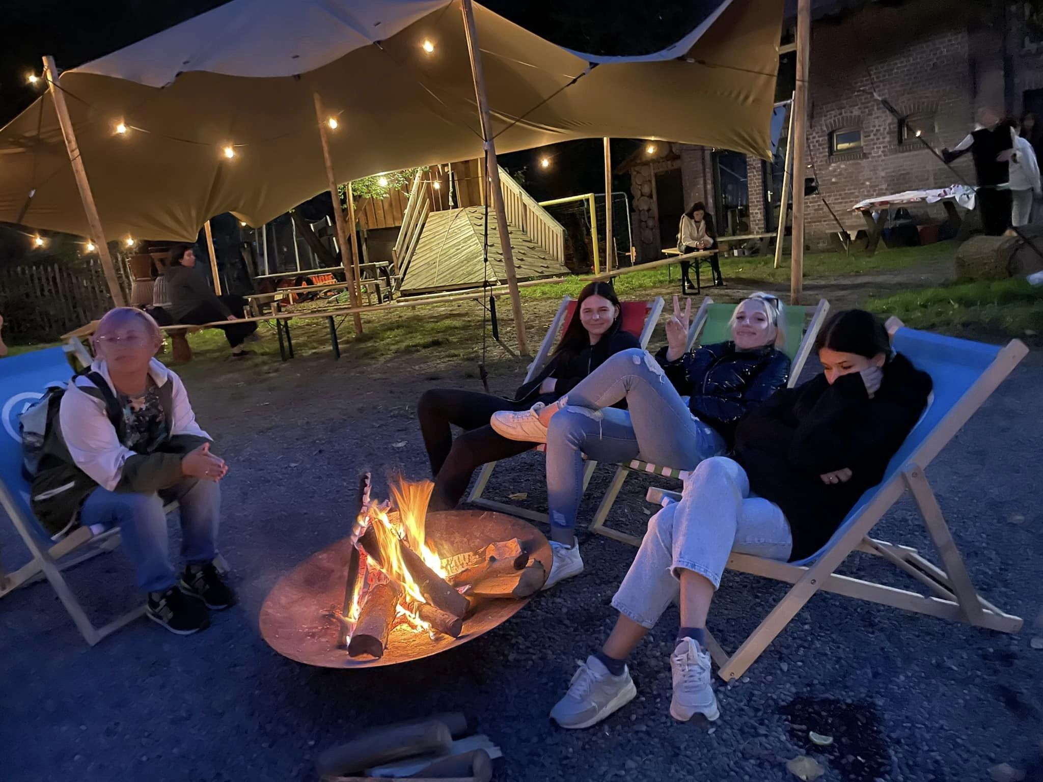 Dziewczyny siedzące wokół ogniska